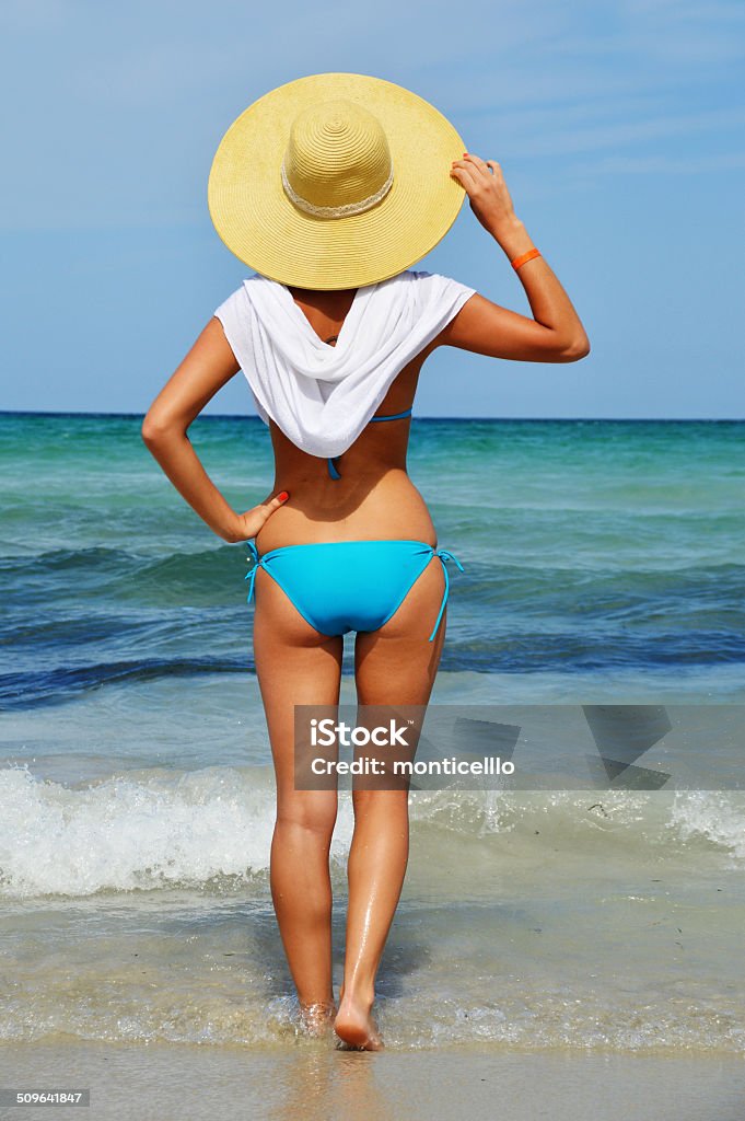 Young woman on the mediterranean beach Young woman on the mediterranean beach during hot summer day Adult Stock Photo