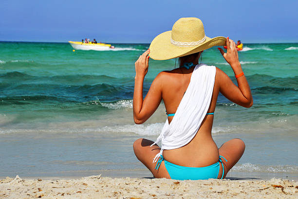 Young woman on the mediterranean beach Young woman on the mediterranean beach during hot summer day tunisia beach stock pictures, royalty-free photos & images