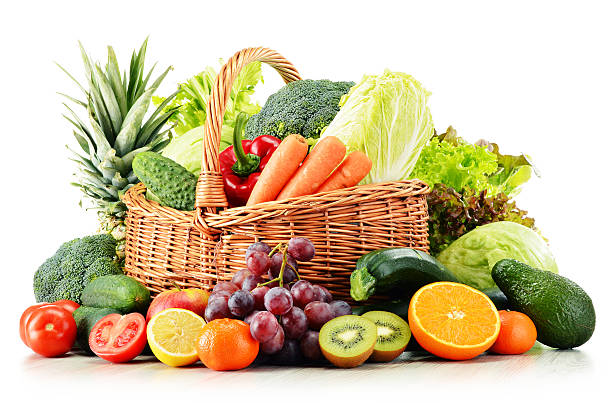 Wicker basket with groceries isolated on white Wicker basket with groceries isolated on white background produce basket stock pictures, royalty-free photos & images