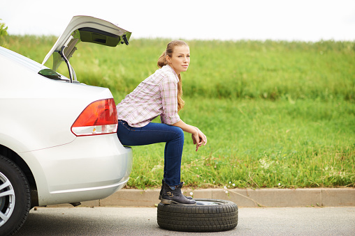 Shot of an attractive young woman sitting and waiting for roadside assistance after getting a flat tirehttp://www.azarubaika.com/iStockphoto/2014_06_16_Victoria_Car.jpg