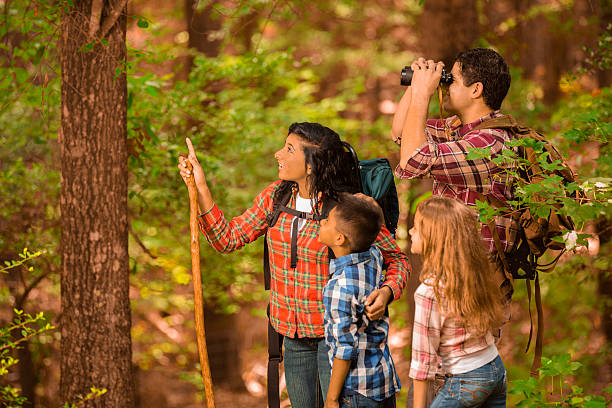 Multi-ethnic family hiking, backpacking outdoors in national park area.