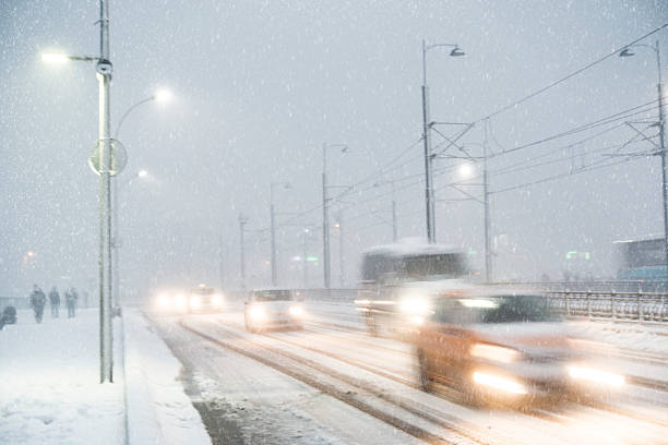 winter traffic scene winter traffic scene with moving cars and cable tram under heavy snow galata photos stock pictures, royalty-free photos & images