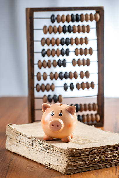 Piggy bank on old book stock photo