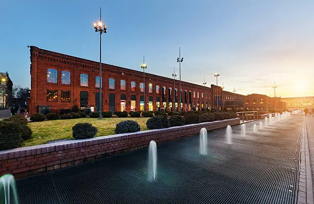 Shopping Mall in Lodz transformed from industrial buildings into elegant place for shopping on the sunset, Poland