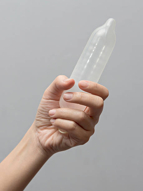istock Female hand holding condom 509659346
