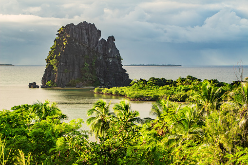 Photo of a picturesque coastline and the Le Poulet (the hen) rock formation near Hienghene, New Caledonia, Grande Terre Island, New Caledonia.