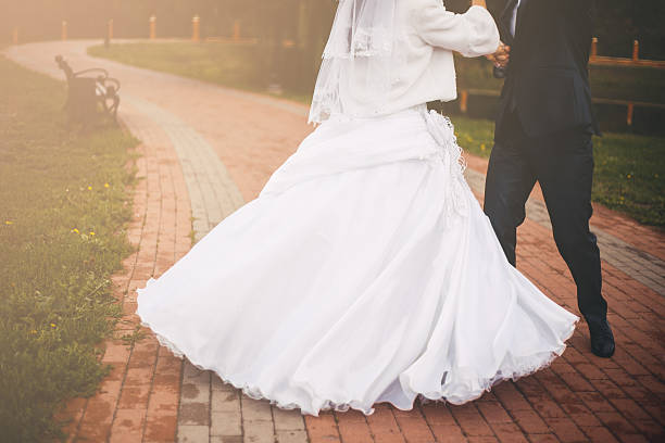 istock Groom and bride are dancing in the park 509661184