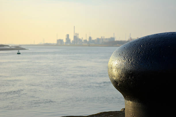 Bollard with Antwerp harbor and Schelde river in background