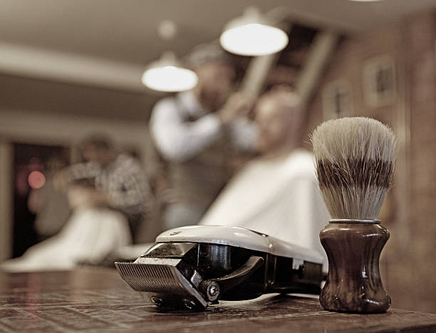 Milan, Italy - March 23, 2016:  Berber works at small barber shop in Milan, Italy