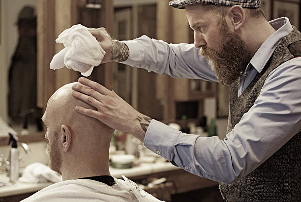 istock Stylish retro bearded barber with a bearded bald male client 509661482