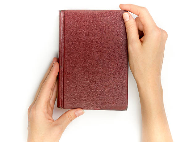 istock Hands hold blank red hardcover book on white background 509661626