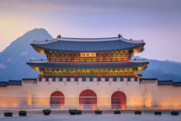 Gyeongbokgung Palace Twilight Sunset Gyeongbokgung Palace At Twilight Sunset In South Korea, with the name of the palace 'Gyeongbokgung' on a sign palace photos stock pictures, royalty-free photos & images