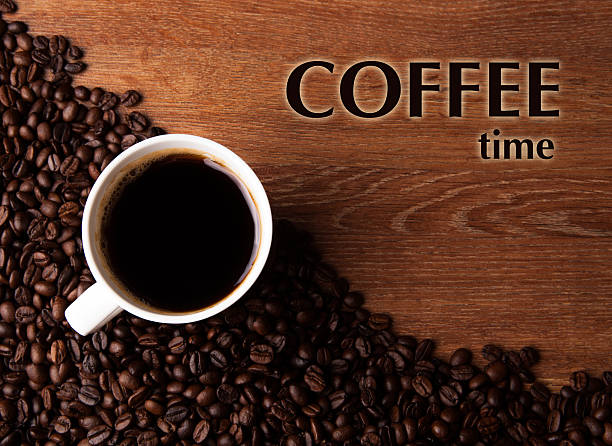 istock cup of black coffee with roasted coffe beans with title coffee time 509662585