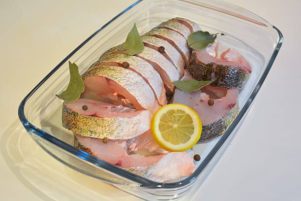 istock Appetizing sliced fish with lemon, pepper and laurel leaf 509665472