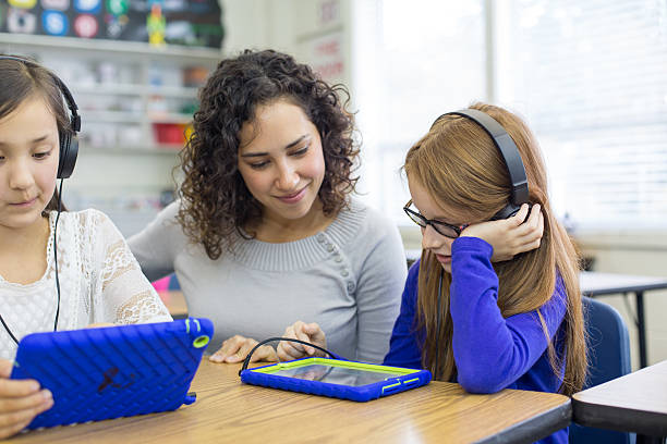 istock Young ethnic teacher works with her elementary school 509670414