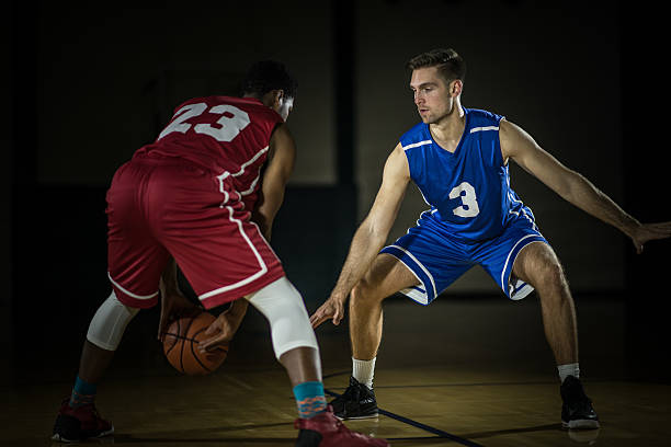 istock Young men playing basketball in a gymnasium 509670636