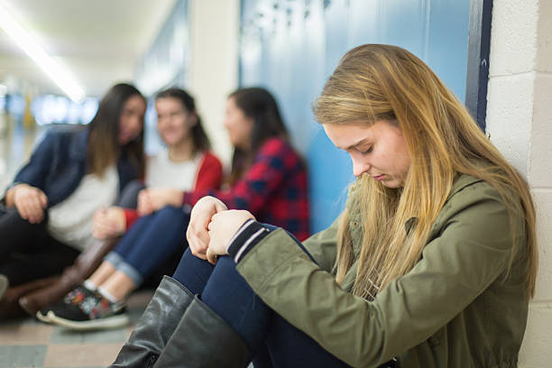 istock Girl getting bullied in high school hallway 509671284