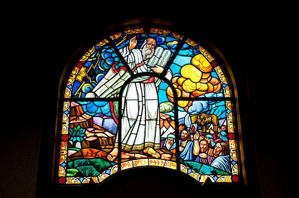 Moses in stained glass - Ethiopia Addis Ababa, Ethiopia - August 1, 2010: Stained glass window depicting Moses holding the Ten Commandments as he finds the Israelites worshipping a golden calf. Photo taken at Holy Trinity Cathedral in Addis Ababa, Ethiopia. addis ababa ethiopia photos stock pictures, royalty-free photos & images