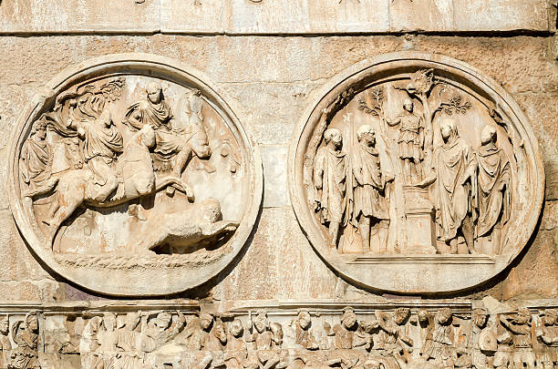 the majesty of old ruins in Rome Detail of a sacrifice to Hercules and the lion hunt on the facade of Constantine's arch in Via dei Fori Imperiali in Rome, Italy costantino stock pictures, royalty-free photos & images