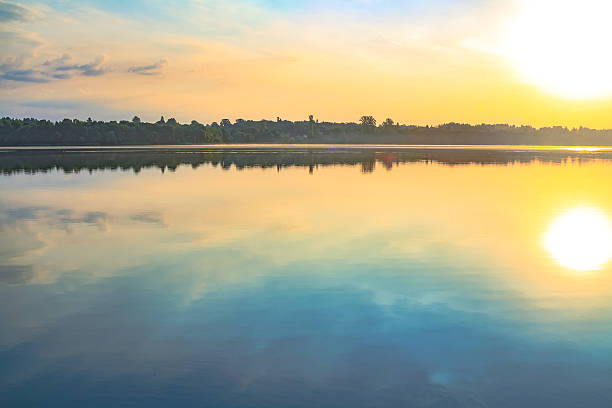 istock Beautiful sunrise over surface of the lake. 509673764
