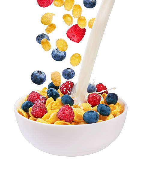 istock Falling corn flakes with fresh berries and pouring milk 509674154