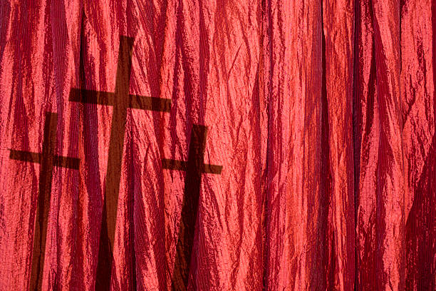 istock Easter. Crucifixion.  Three crosses in shadows on red curtains. 509678512