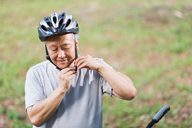 istock Asian man putting on bike helmet 509680697