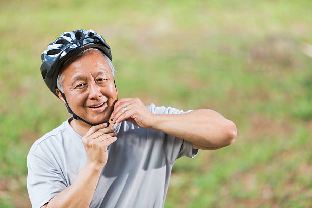 istock Asian man putting on bike helmet 509680757
