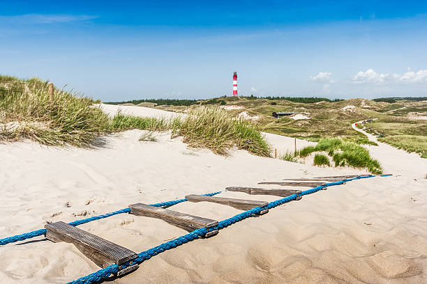 Beautiful dune landscape with lighthouse at North Sea Beautiful dune landscape with traditional lighthouse on the island of Amrum at North Sea, Schleswig-Holstein, Germany. amrum stock pictures, royalty-free photos & images