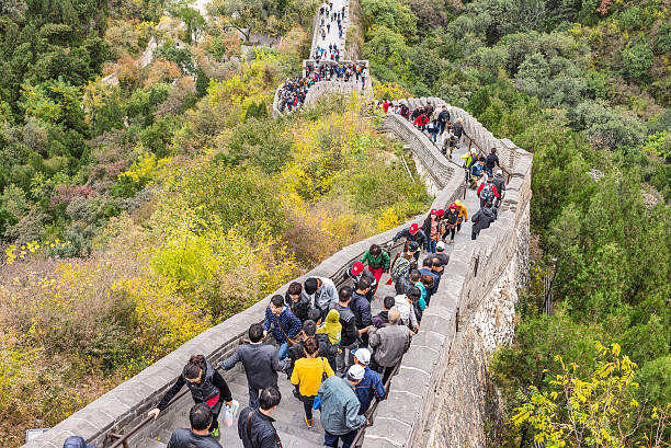 Beijing, China - October 14, 2013: A view of the Great Wall in Beijing, China. The Visitors are both locals and foreigners. They walk up and down the steep stairs on a cloudy day.