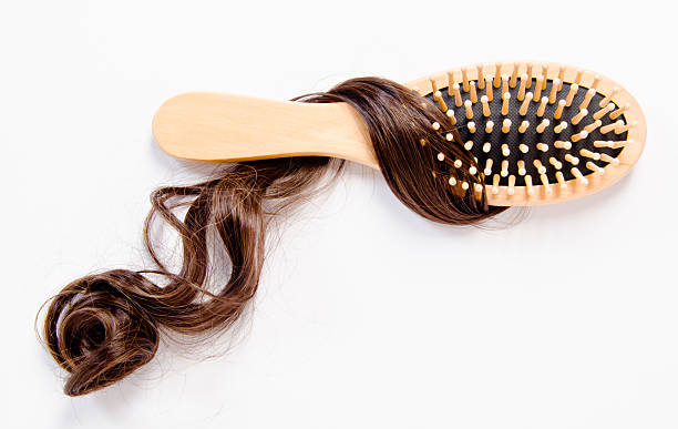 istock wooden comb brush with hair. 509685155