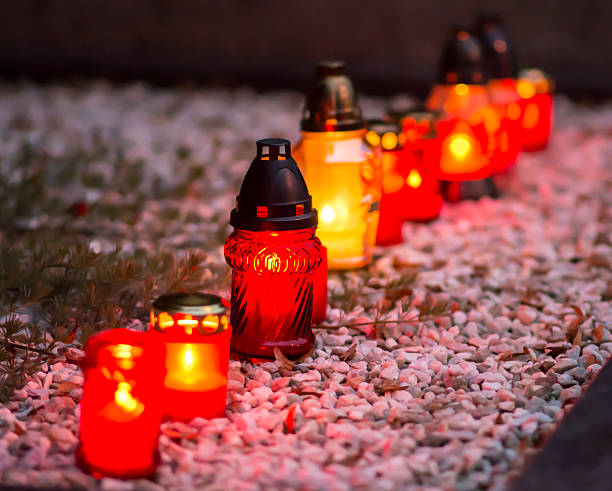 istock Flaming colored candle on the grave 509686942