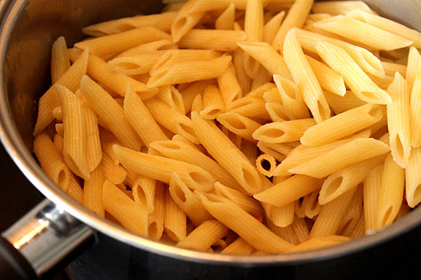 istock Image of freshly cooked penne pasta in saucepan, awaiting sauce 509687111