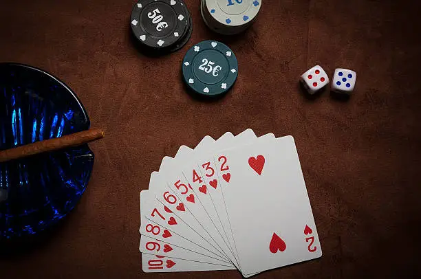 Poker chips and generic playing cards. Courts for poker chips and dice on table
