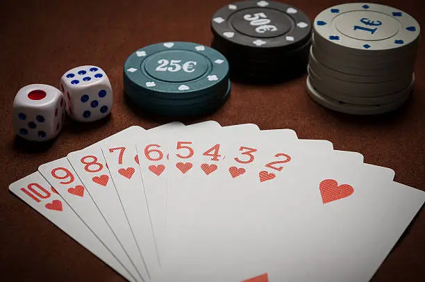 Poker chips and generic playing cards. Courts for poker chips and dice on table