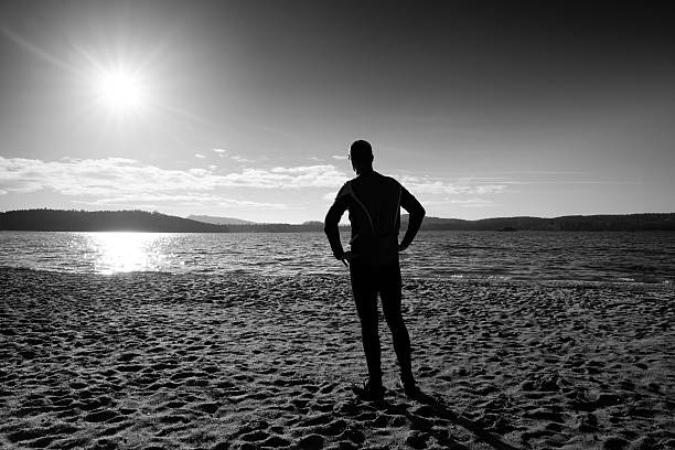 istock Active adult man running and exercising on the beach. 509687386