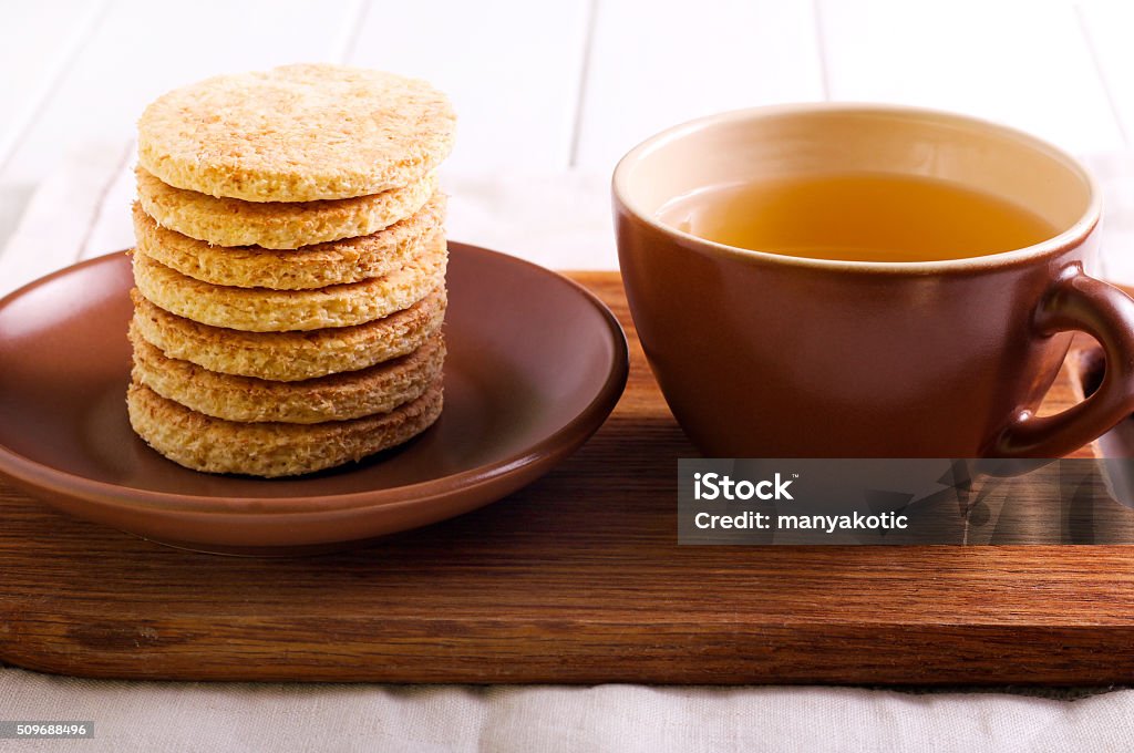 Coconut biscuits and cup of tea Coconut biscuits and cup of tea on napkin Baked Stock Photo