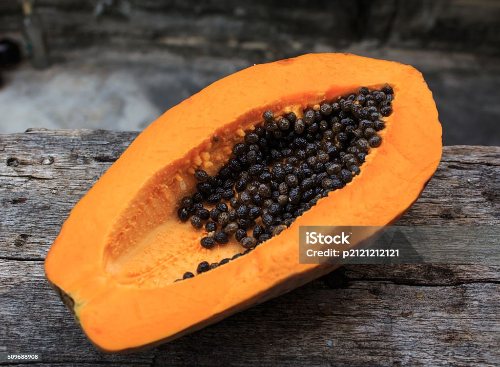 Sliced fresh papaya on wooden background Asia Stock Photo