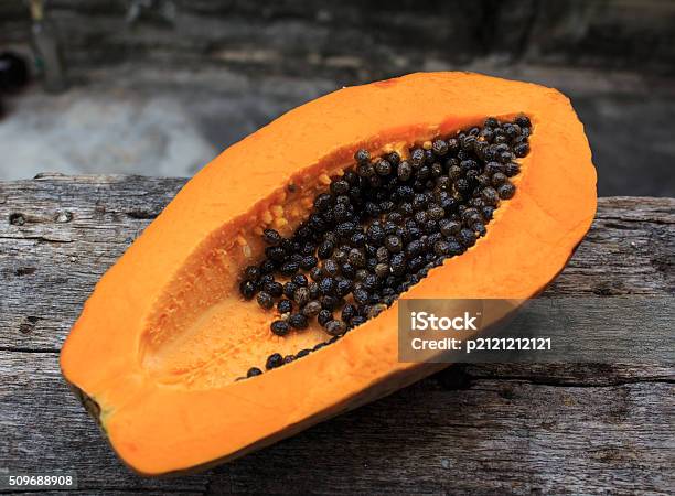 Sliced Fresh Papaya On Wooden Background Stock Photo - Download Image Now - Asia, Backgrounds, Black Color