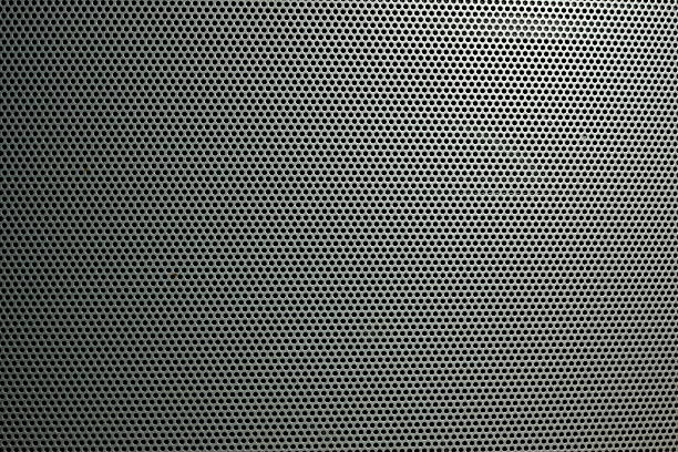 Speaker grille on the big theater speaker shot closeup Technology background with seamless circle perforated carbon speaker grill texture for internet sites, web user interfaces (ui) and applications (apps) wire mesh stock pictures, royalty-free photos & images