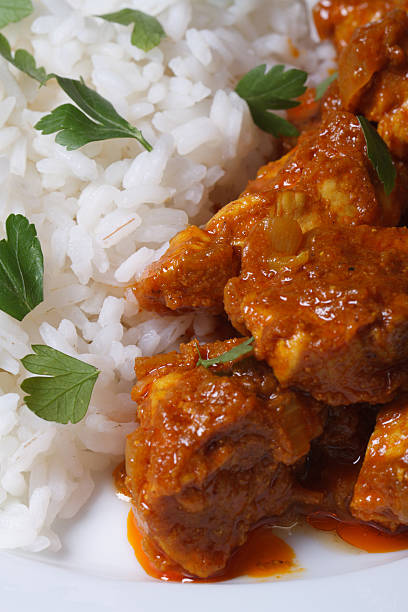 istock Rice and pieces of chicken in curry macro 509701617