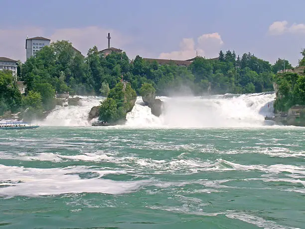 The Rhine Falls is the largest plain waterfall in Europe. The falls are located on the High Rhine between the municipalities of Neuhausen am Rheinfall and Laufen-Uhwiesen, near the town of Schaffhausen in northern Switzerland, between the cantons of Schaffhausen and Zürich. They are 150 m (450 ft) wide and 23 m (75 ft) high.