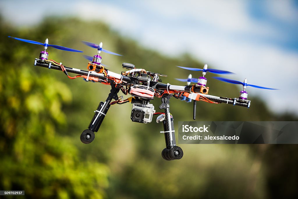 Drone Professional carbon drone with GPS making a ride. Blue Stock Photo