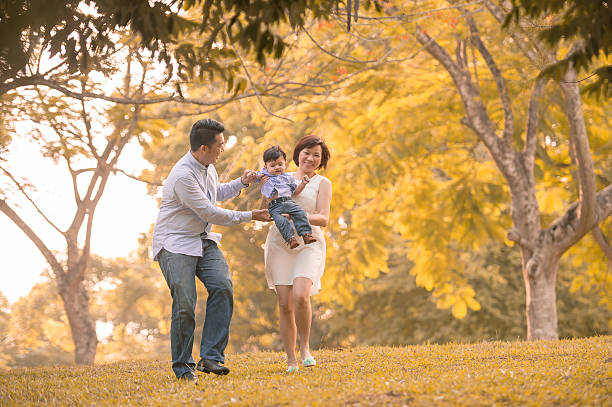 istock Asian young family having fun outdoors in autumn 509703389