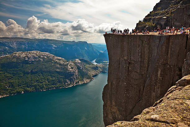 Pulpit Rock, Norway Preikestolen, Norway - July 28, 2014: Pulpit Rock (Preikestolen) is one of the most favourite attractions in Norway. Its a rock 600m above the Lysefjord. During the Summer there are a lot of people there - local people and tourists. lysefjorden stock pictures, royalty-free photos & images
