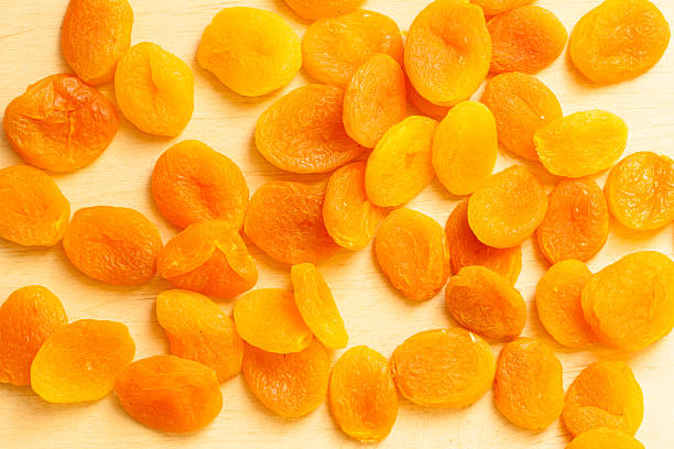 istock Healthy diet. Dried apricots set on wooden table . 509704703