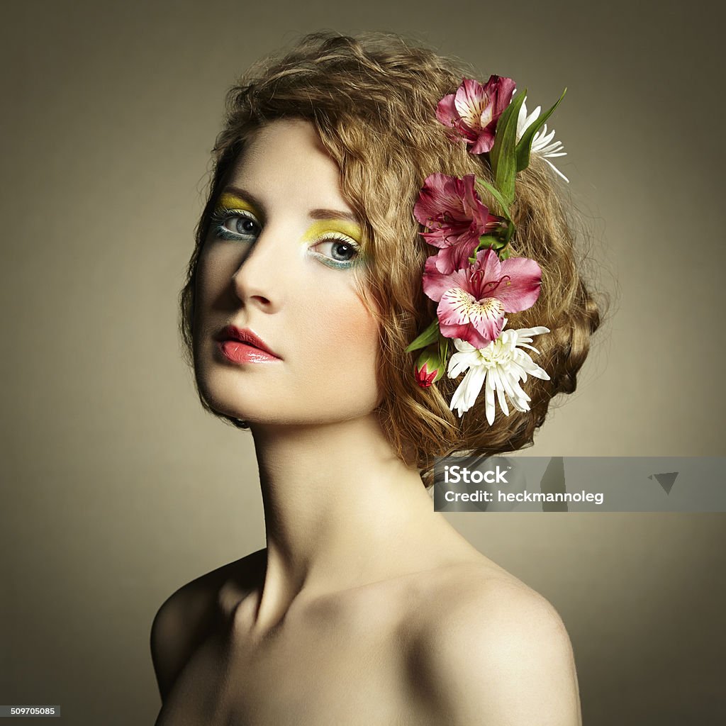 Beautiful young woman with delicate flowers in their hair Beautiful young woman with delicate flowers in their hair. Spring photos Adult Stock Photo