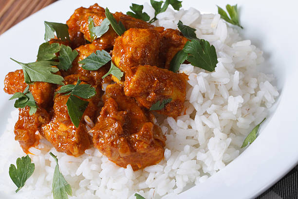istock Chicken breast curry with rice on a white plate 509705383