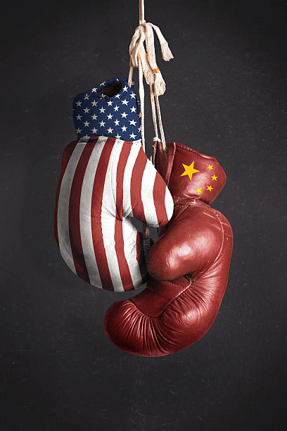 Symbol, struggle for economic power between the United State Symbol, struggle for economic power between the United States and China fist human hand punching power stock pictures, royalty-free photos & images