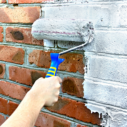 Paint roller through a brick wall